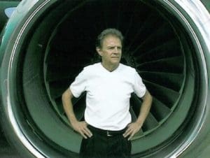 A man standing in the middle of an airplane engine.